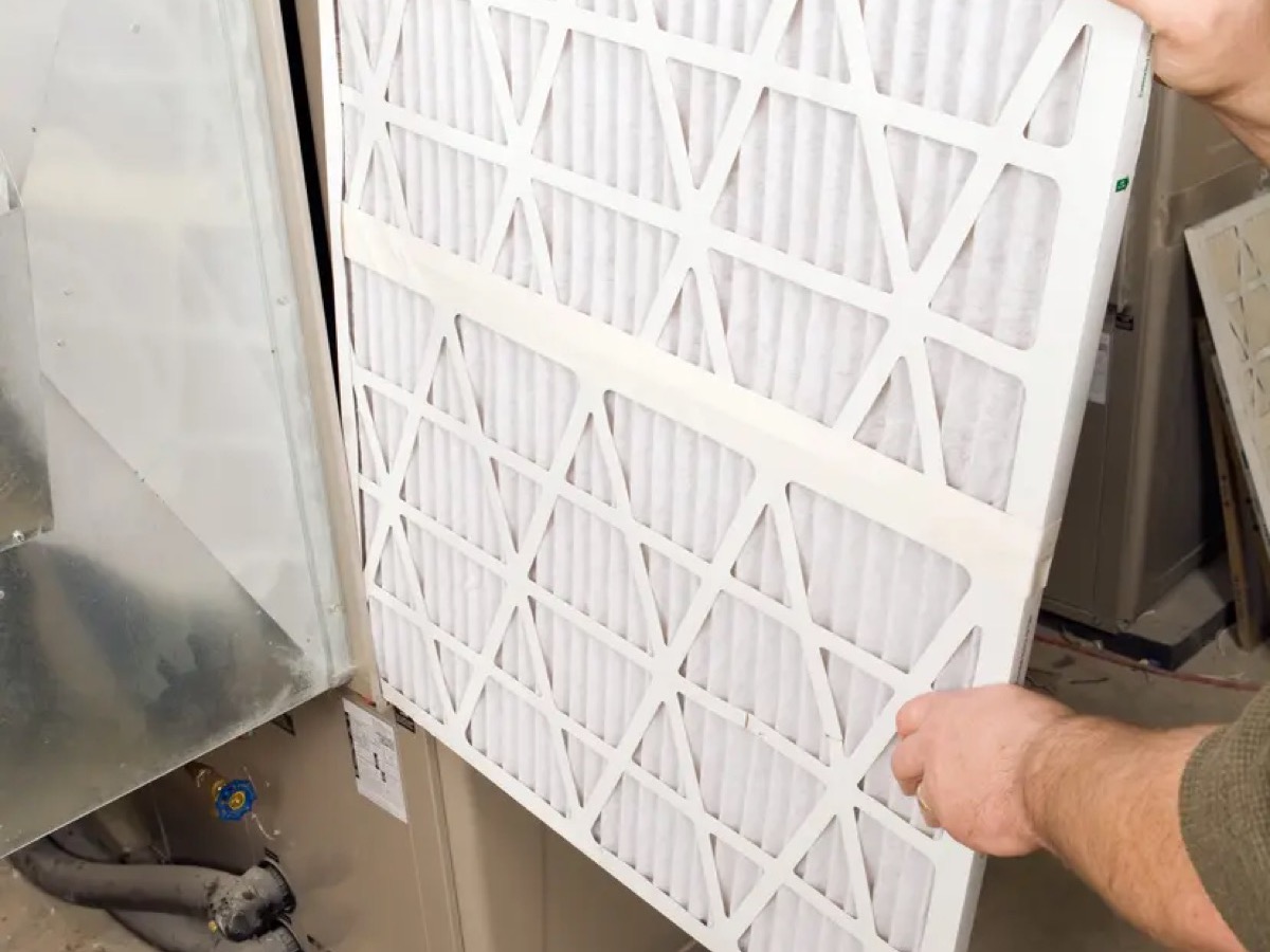 Furnace technician inspecting a residential heating system